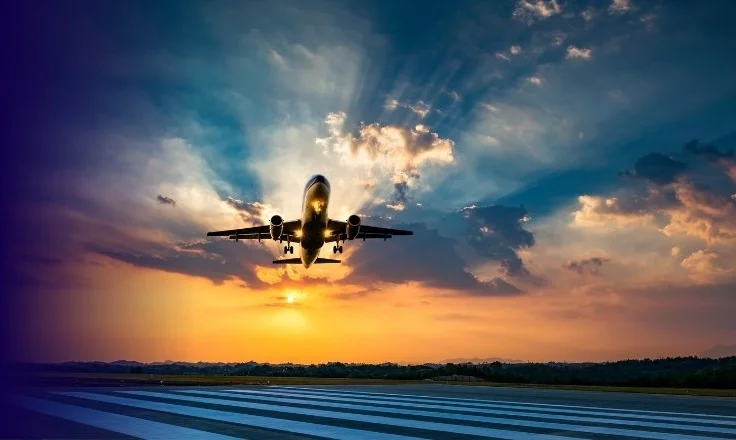 plane taking off in sunset